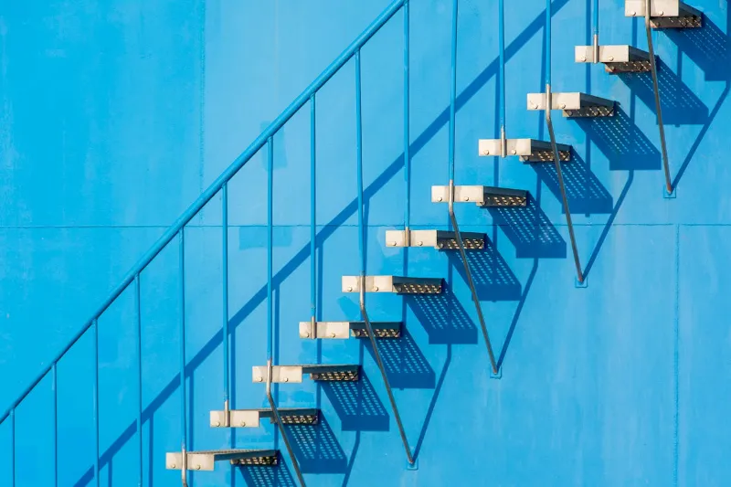 A 7-Step Guide to Professional Website Design for Therapists View of a Staircase Outside of a Blue Building